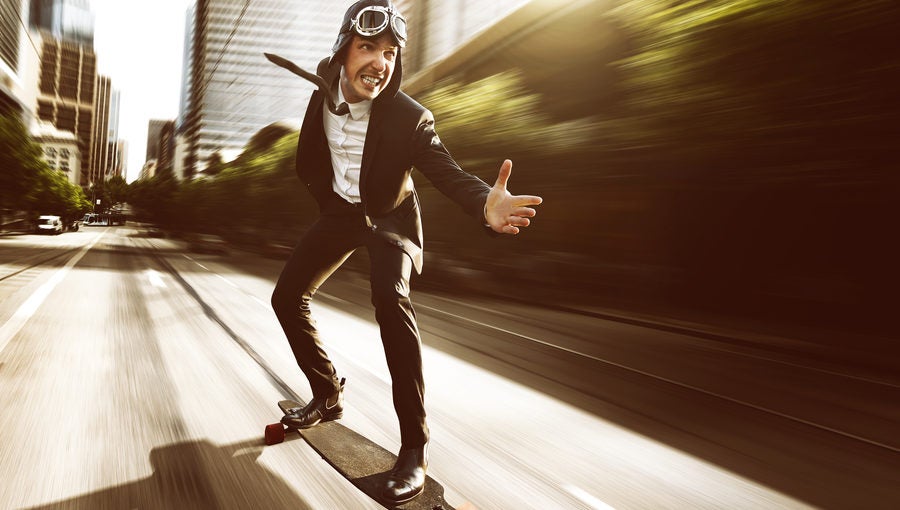 Businessman on speeding skateboard