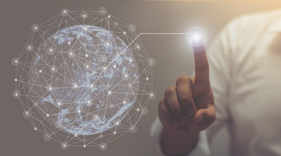 Faceless "CIO" draws a new network branch from a transparent globe that is covered in a network grid.