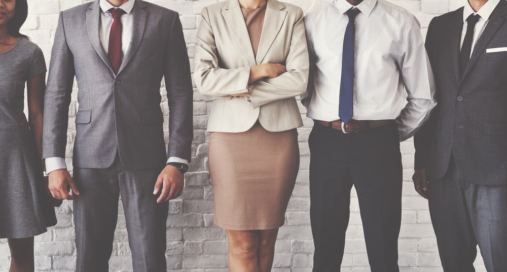 Row of office workers, standing in various postures