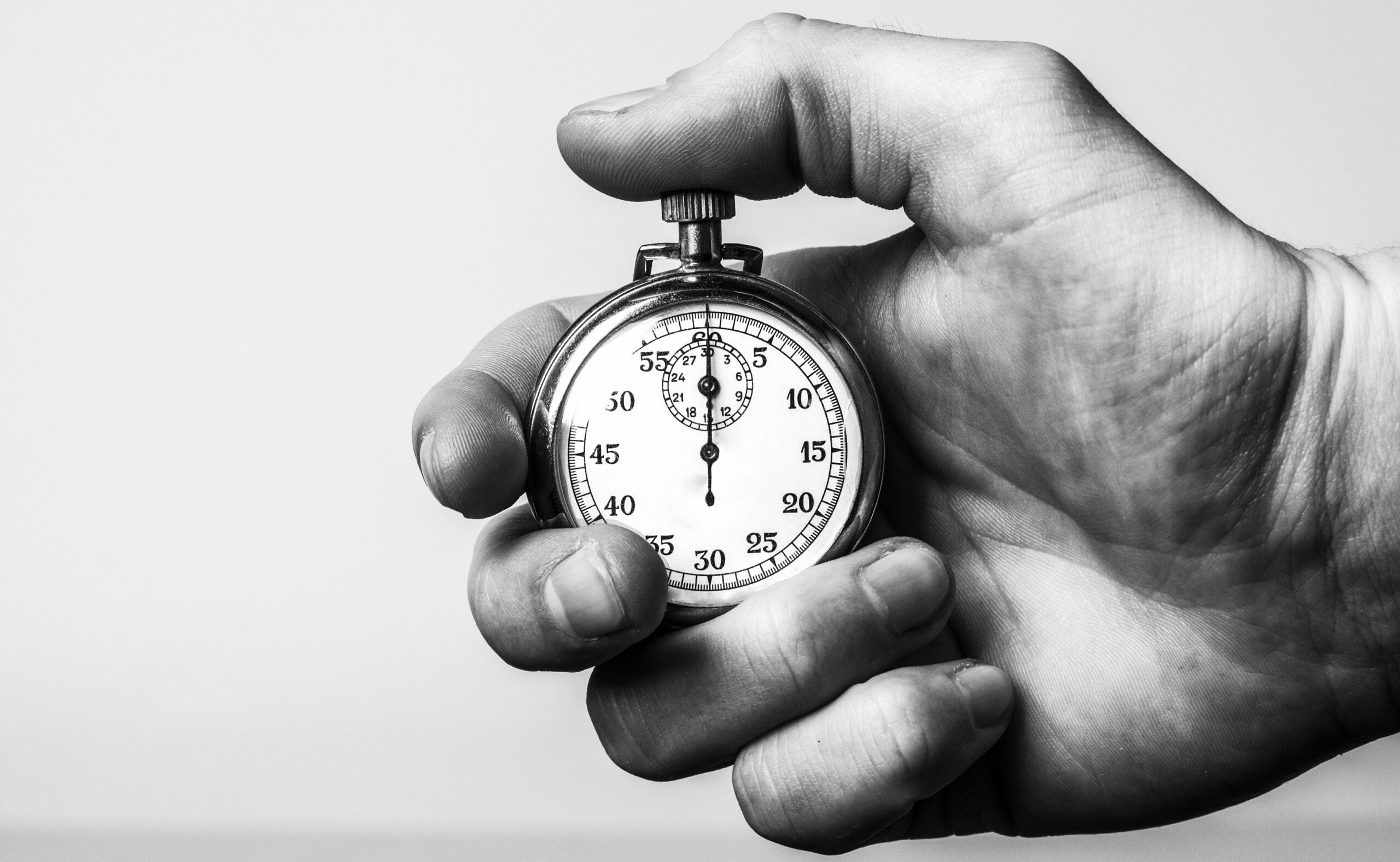 Hand holding a retro stopwatch, black & white phot