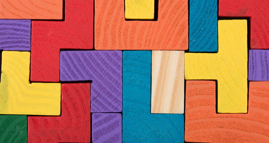 Colored jigsaw blocks puzzle. Business creative solution concept - jigsaw on the blackboard